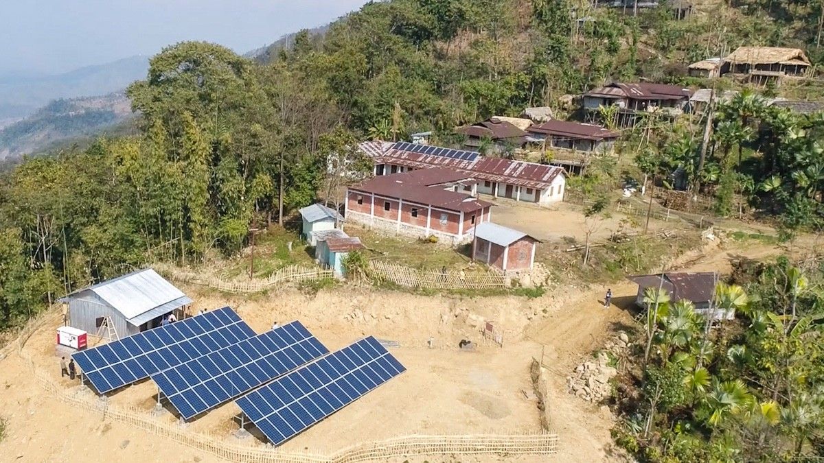 Ground-mount solar array beside a village, Nagaland, India